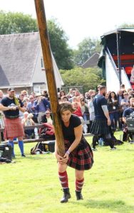 Dr. Sarah Zipp, tossing a caber at the Bridge of Allan Highland Games (Scotland, UK)
